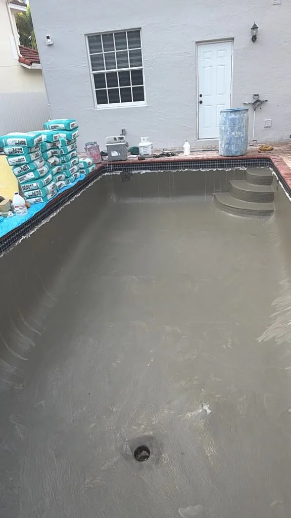 Pool Vice applying Diamond Brite pool finish, view 1