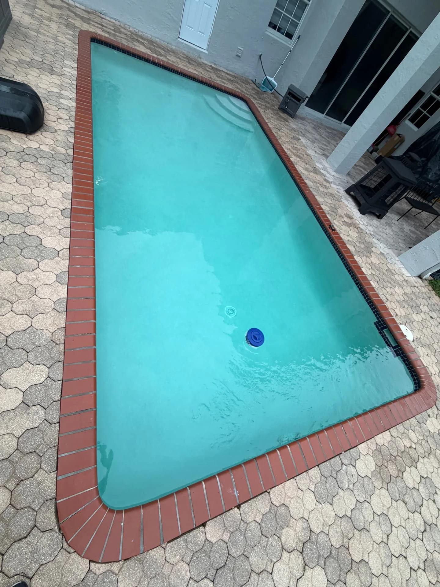 Bright blue residential pool after Pool Vice resurfacing