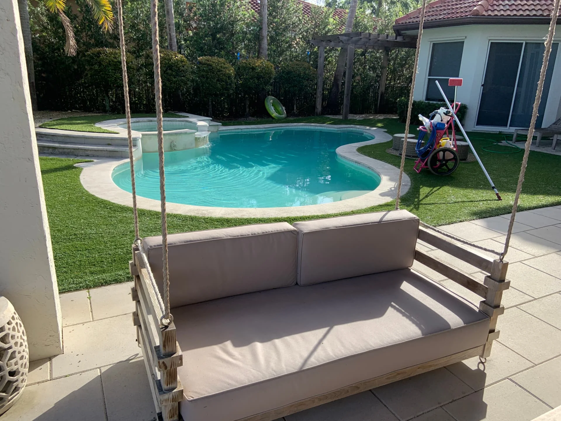 Backyard pool with Pool Vice service cart near Miami Beach, Florida