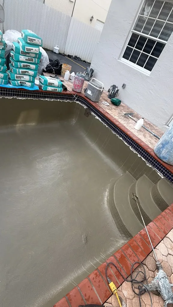 Pool Vice applying Diamond Brite pool finish, view 2