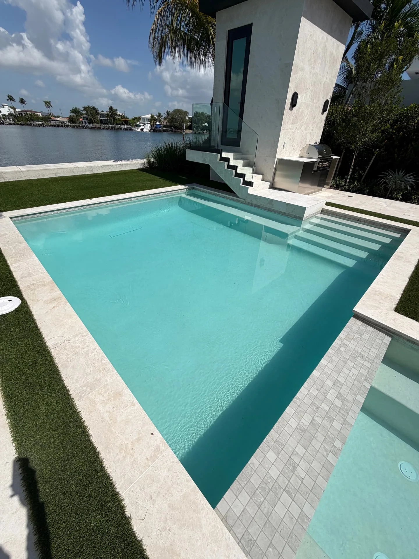 Modern square waterfront pool prepared for new pool startup service